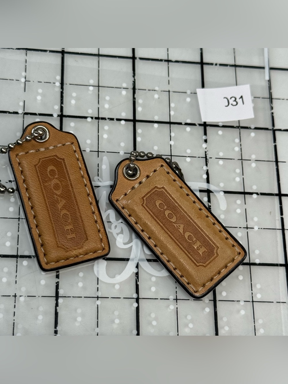 Coach two small Tan Leather Hang Tag Keychain Set. 2 by 1 inches. One with wear - Picture 4 of 5